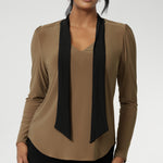 The soft V-neckline is accented by attached neck ties in a warm coffee tone, offering styling versatility—wear them tied for a polished office look or leave them loose for a more relaxed, contemporary feel. Full-length sleeves with gentle gathers at the shoulders add a touch of femininity, while the shoulder yoke and tailored tuck at the back create subtle shape without feeling structured.