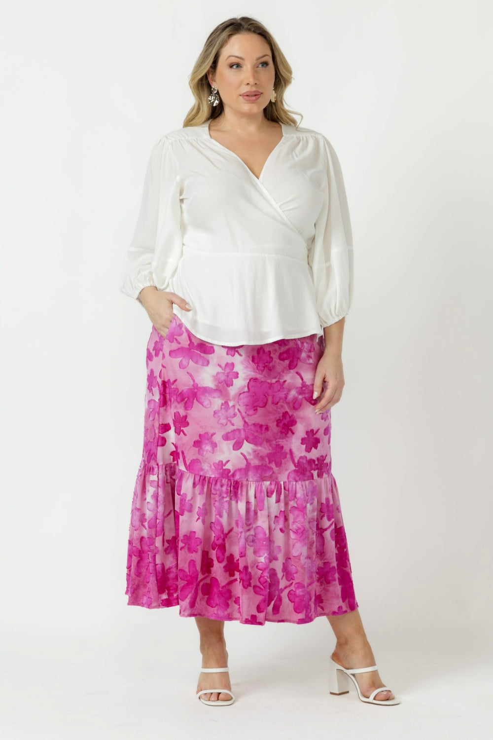 Elegant Tova pull-on skirt crafted from soft stretch burnout fabric with a textured finish, side pockets and graceful flowing frill hemline.