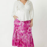 Elegant Tova pull-on skirt crafted from soft stretch burnout fabric with a textured finish, side pockets and graceful flowing frill hemline.
