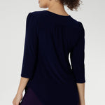Styled with fluid suiting, the Vida Top creates a polished, professional look while remaining versatile enough for casual wear. Shown from the back, the clean lines and refined silhouette highlight its easy fit and timeless appeal. Proudly made in Australia and available in inclusive sizes 8 to 24.