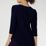 Styled with fluid suiting, the Vida Top creates a polished, professional look while remaining versatile enough for casual wear. Shown from the back, the clean lines and refined silhouette highlight its easy fit and timeless appeal. Proudly made in Australia and available in inclusive sizes 8 to 24.