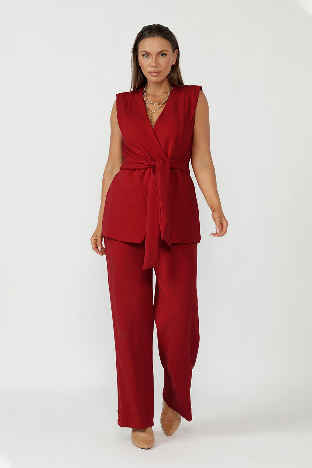 Structured red vest for women with extended shoulders and sculpted fit, modern workwear and occasion layering