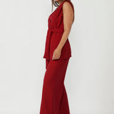Australian-made women’s vest in flame red scuba jersey with tailored silhouette and waist-defining belt.