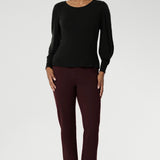 The boat neckline frames the collarbone with subtle sophistication, while tailored bust darts and a close-to-body shape enhance the fit without feeling restrictive. Crafted with attention to detail, the full-length sleeves feature gentle gathers at the shoulder and a wrist dart, adding soft volume and movement—ideal for styling under outerwear without bulk.