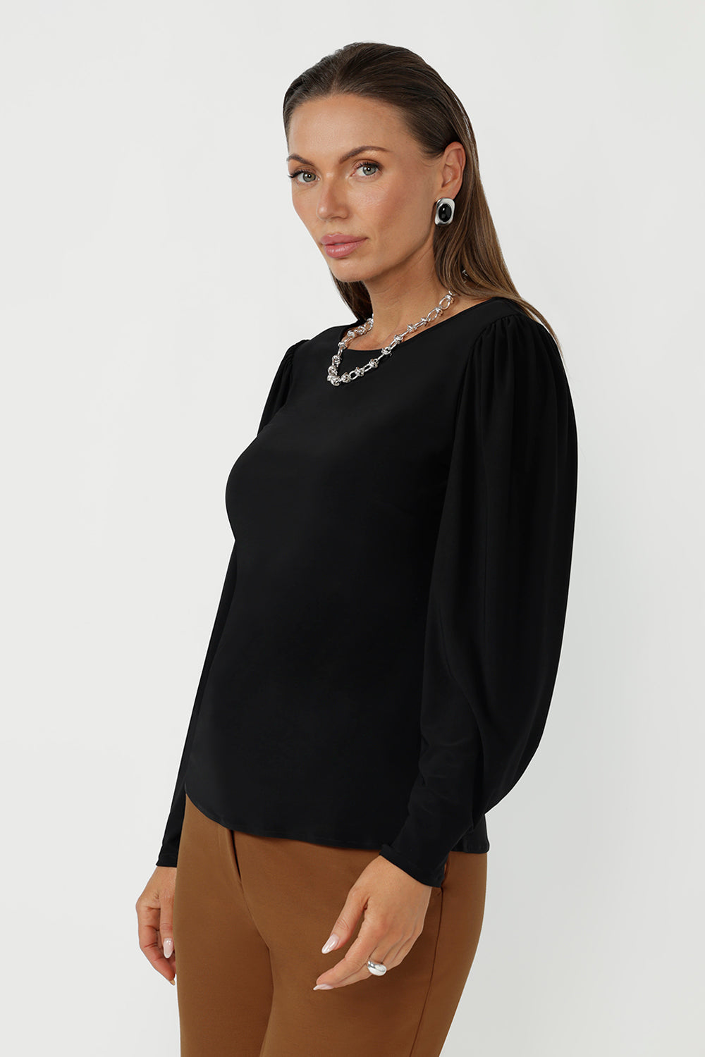 The Zara Top in Black blends comfort and sophistication, making it a go-to for women’s workwear and elevated basics. Crafted from stretch fabric with a fitted silhouette and curved hem detail, it delivers effortless, all-day wear.