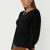 The Zara Top in Black blends comfort and sophistication, making it a go-to for women’s workwear and elevated basics. Crafted from stretch fabric with a fitted silhouette and curved hem detail, it delivers effortless, all-day wear.