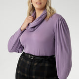 This Lilac hue adds a touch of colour to grey days, pairing effortlessly. Plus size model wears her Lilac Top with plaid printed pants with tailored wide leg design. 